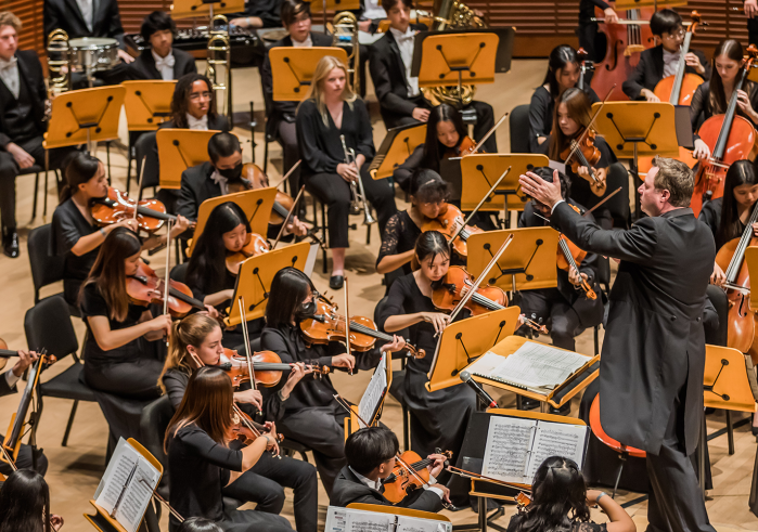Man conducting orchestra from podium